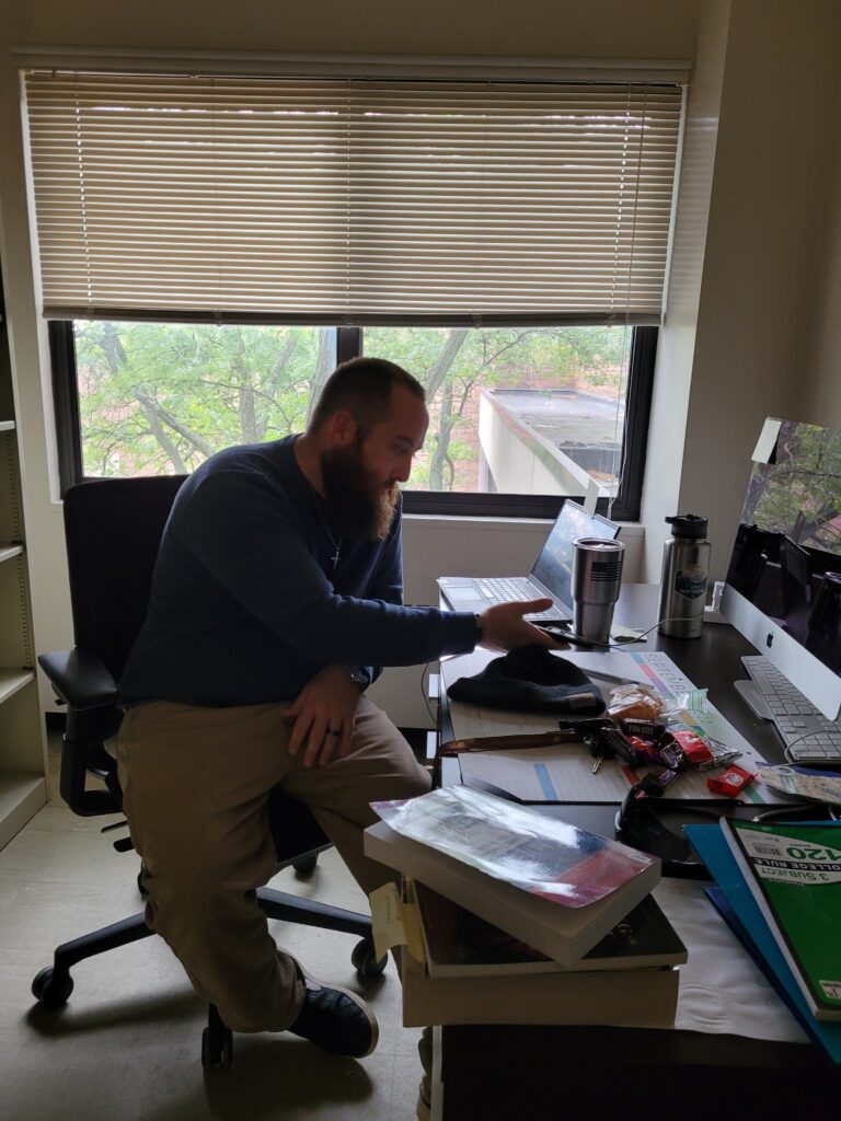 Picture of Dean Wetzel studying and working on his veteran history project and story in his college office