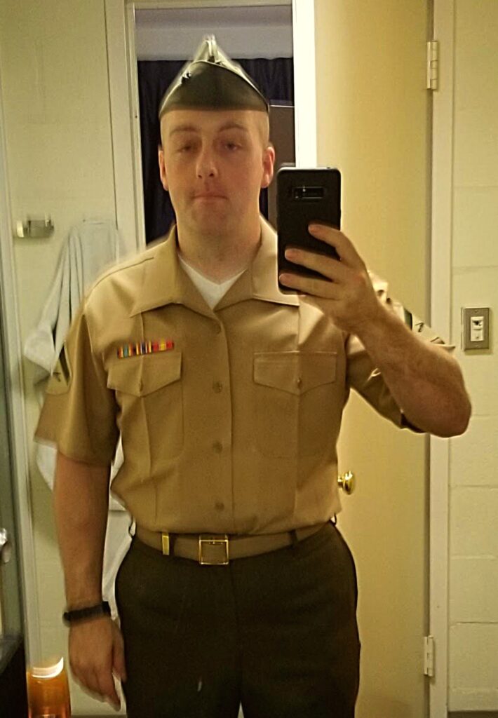 Dean Wetzel taking a picture of himself in his Marine Corps uniform.