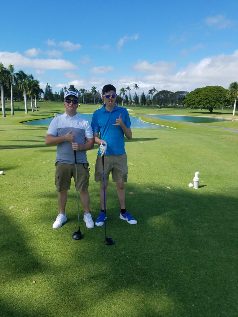 Two Marine Corps members playing golf in Hawaii.