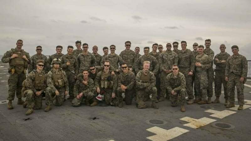 a group picture of Marine Corps troop on the flight deck, part of his story