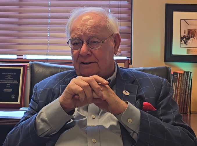 A United States Navy veteran, John Schwarz, sitting in his office for an interview for the Veteran Oral History Project. 