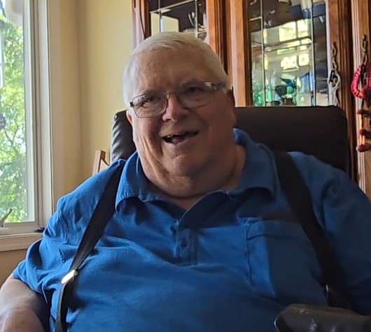 A picture of a United States Marine Corp veteran, John McManus in his home being interviewed by Dean Wetzel. 